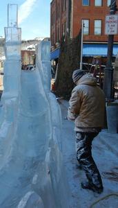 Ted Struckman of Struckman Sculpture Ice, carving an ice slide at a Colorado Winter Festival.